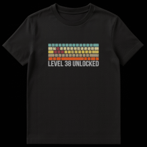 Retro arcade style graphic with colorful bricks and text reading Level 38 Unlocked for a 38th birthday t-shirt design on Black t-shirt