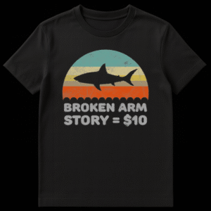 Distressed retro sunset graphic with a shark silhouette and text reading Broken Arm Story equals 10 dollars on Black t-shirt