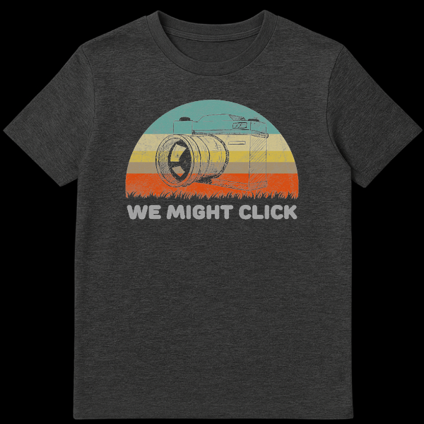 Vintage style t-shirt design featuring a sketch of an SLR film camera in front of a retro striped sunset with the text We Might Click below it on Dark Heather t-shirt