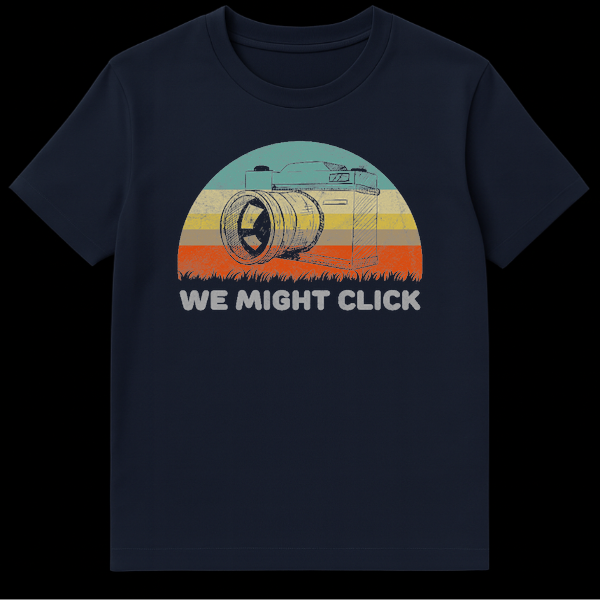Vintage style t-shirt design featuring a sketch of an SLR film camera in front of a retro striped sunset with the text We Might Click below it on Navy Blue t-shirt