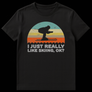 Vintage retro skiing t-shirt with a sunset over snow, a skier silhouette, and the text 'I JUST REALLY LIKE SKIING, OK?' on a black background. on Black t-shirt