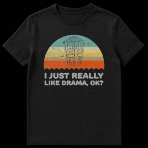 Black t-shirt with retro-style graphic featuring distressed vintage striped arc, two black-outlined popcorn buckets with 'POP CORN' emblem, and light gray distressed text 'I JUST REALLY LIKE DRAMA, OK?' centered below. on Black t-shirt