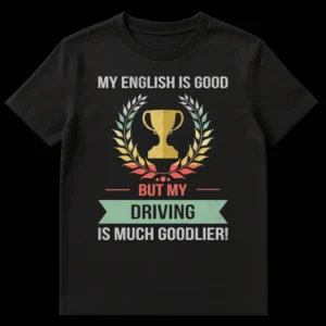 Vintage distressed black t-shirt with a muted gold trophy and green laurel wreath, featuring white and coral text that reads 'MY ENGLISH IS GOOD BUT MY DRIVING IS MUCH GOODLIER!' on Black t-shirt