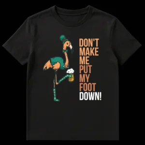 Funny St. Patrick's Day t-shirt with a cartoon flamingo wearing a leprechaun hat, vest, and bow tie, holding a beer. The flamingo is standing on one leg, with the other raised, and the text reads 'DON'T MAKE ME PUT MY FOOT DOWN!' on Black t-shirt
