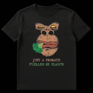 Distressed comic style graphic t-shirt featuring an intense gorilla eating broccoli with text 'JUST A PRIMATE FUELLED BY PLANTS' in tan and green colors. on Black t-shirt
