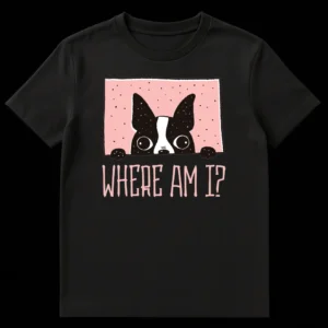 Cute black and white Boston Terrier dog peeking over a pink frame with 'WHERE AM I?' text, on a black t-shirt. on Black t-shirt