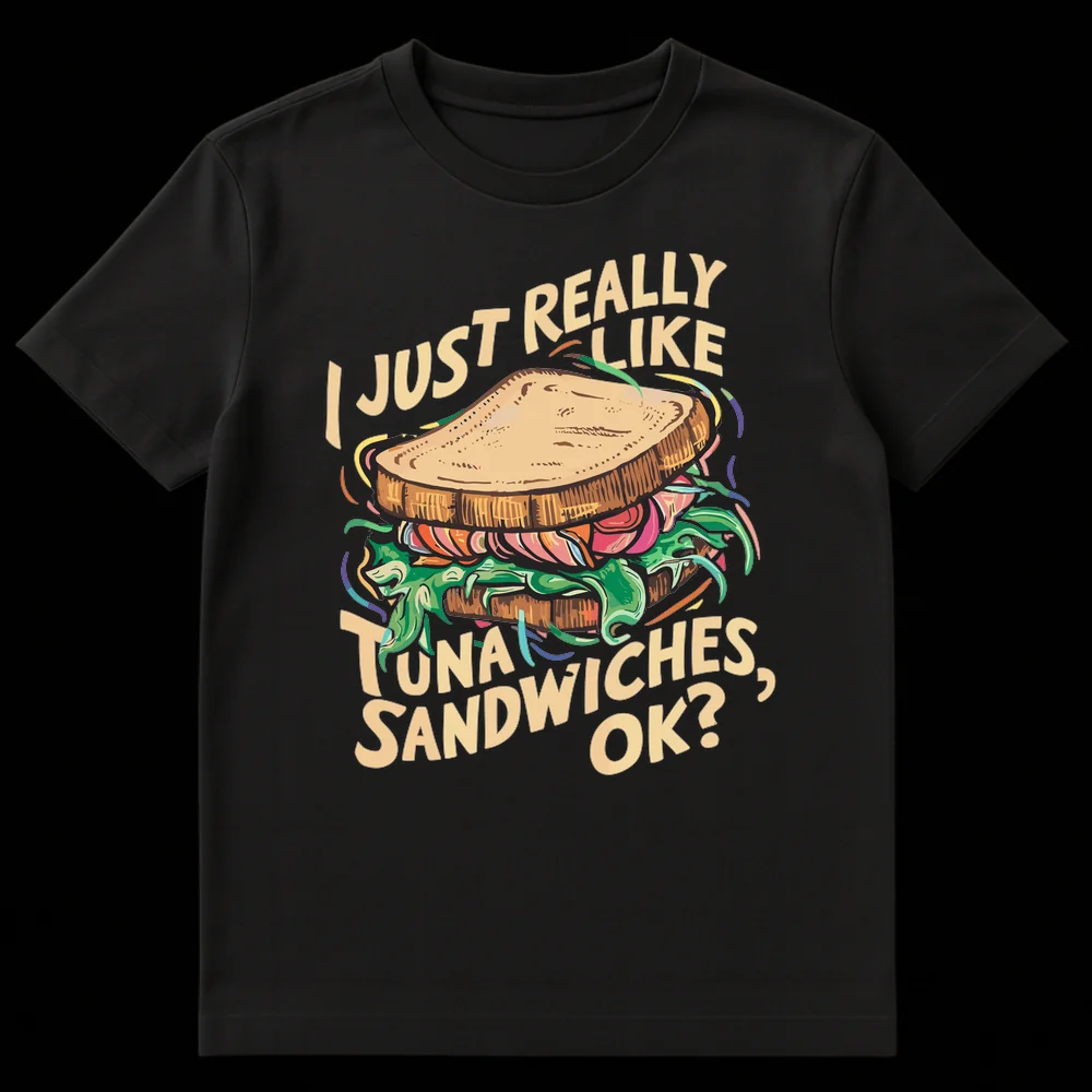Humorous black t-shirt with a cartoon tuna sandwich and the text 'I JUST REALLY LIKE TUNA SANDWICHES, OK?' in cream color. on Black t-shirt