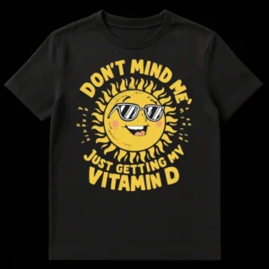 Funny sun cartoon t-shirt with sunglasses and text 'DON'T MIND ME, JUST GETTING MY VITAMIN D' on Black t-shirt