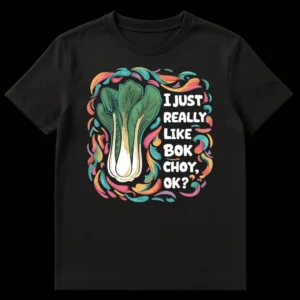 Black t-shirt with vibrant, hand-drawn illustration of bok choy framed by colorful swirls, and white text 'I JUST REALLY LIKE BOK CHOY, OK?' on Black t-shirt