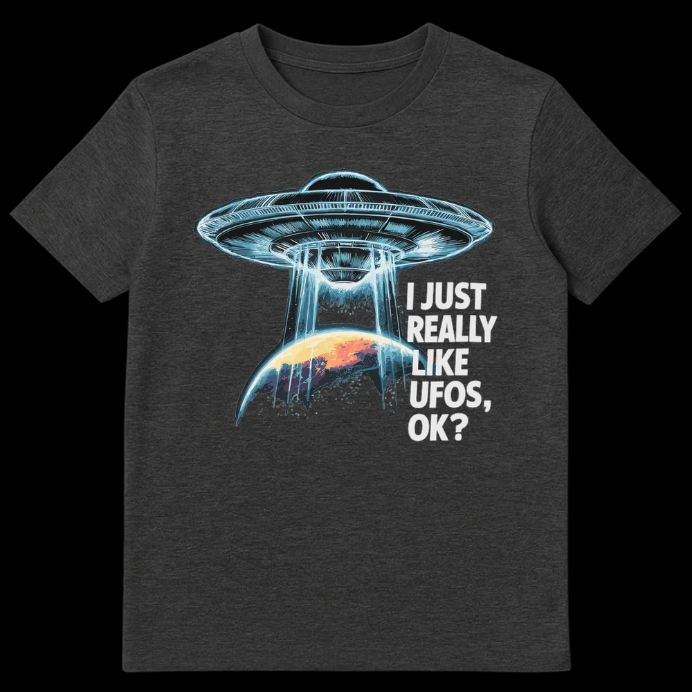 UFO Enthusiast Unisex T-Shirt with 'I JUST REALLY LIKE UFOS, OK?' text, featuring a detailed flying saucer, tractor beam, and planet design on a black background. on Dark Heather t-shirt