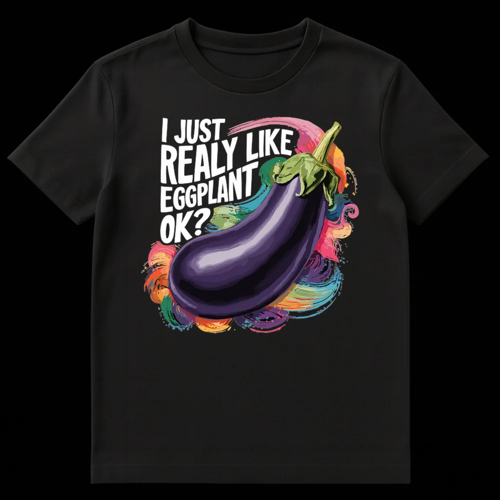Black t-shirt with 'I JUST REALLY LIKE EGGPLANT OK?' text above a vibrant, semi-realistic eggplant illustration surrounded by colorful paint splashes on Black t-shirt