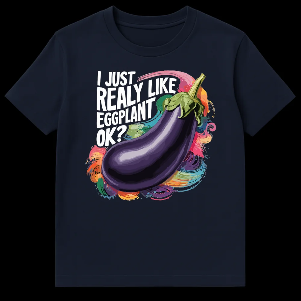 Black t-shirt with 'I JUST REALLY LIKE EGGPLANT OK?' text above a vibrant, semi-realistic eggplant illustration surrounded by colorful paint splashes on Navy Blue t-shirt