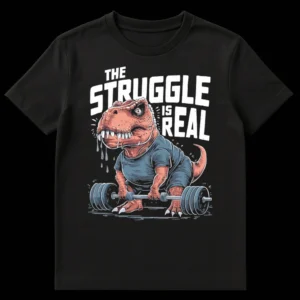 Cartoon T-Rex struggling to lift a barbell, wearing a t-shirt, with the text 'THE STRUGGLE IS REAL' above it. The dinosaur is sweating profusely and its face shows extreme effort. on Black t-shirt