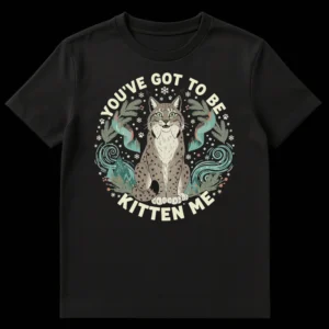 Humorous 'You've Got To Be Kitten Me' t-shirt with a smiling lynx and winter forest elements, ideal for cat lovers and pun enthusiasts. on Black t-shirt