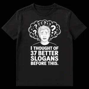 Black and white t-shirt with comic art of a man looking frustrated with question marks and text 'I THOUGHT OF 37 BETTER SLOGANS BEFORE THIS.' on Black t-shirt