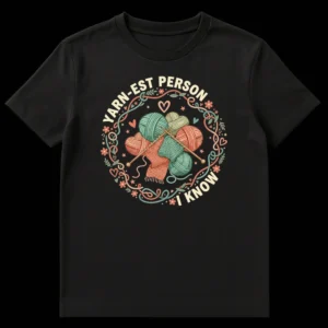 Whimsical black t-shirt with 'YARN-EST PERSON I KNOW' text, featuring hand-drawn yarn balls, knitting needles, and a heart-shaped yarn, encircled by a decorative wreath in teal, coral, and cream colors. on Black t-shirt